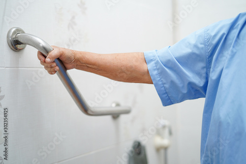 Asian senior or elderly old lady woman patient use toilet bathroom handle security in nursing hospital ward : healthy strong medical concept.  .