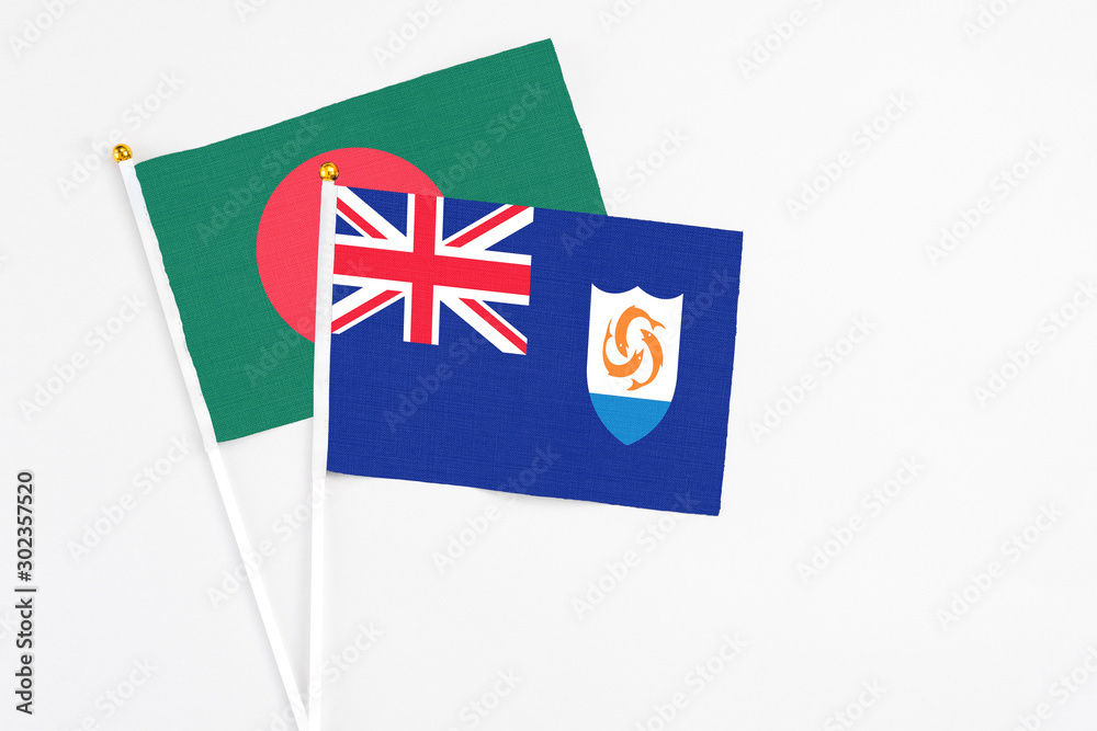 Fototapeta premium Anguilla and Bangladesh stick flags on white background. High quality fabric, miniature national flag. Peaceful global concept.White floor for copy space.