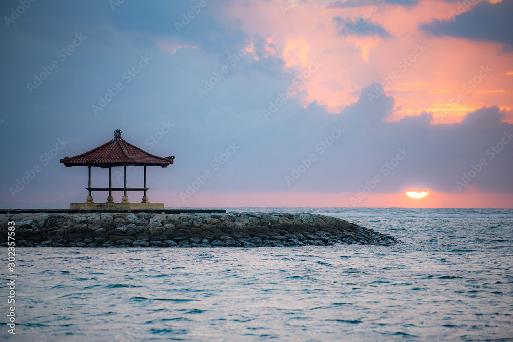 Cozy small traditional wooden house at Bali beach shot when sunset or sunrise. Enjoy fresh windy beach at small teak house in the morning or afternoon. Cozy small traditional wooden house at Bali beach shot when sunset or sunrise. Enjoy fresh windy beach at small teak house in the morning or afternoon.
