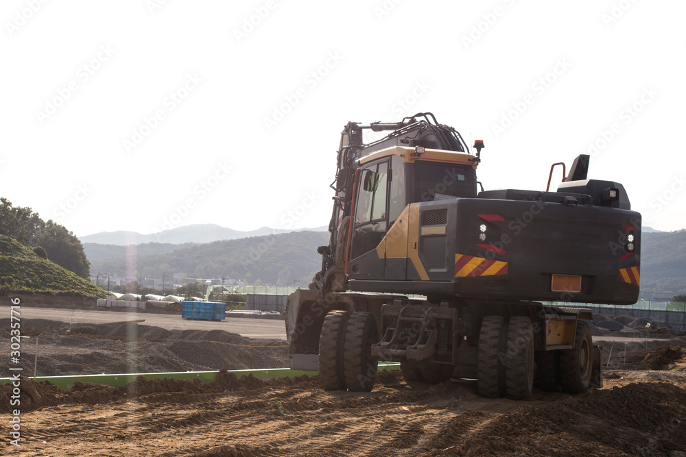 The excavator is working excavation site construction The excavator is working excavation site construction