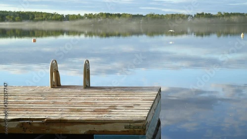 Floating dock with ladder on a peaceful serene lake