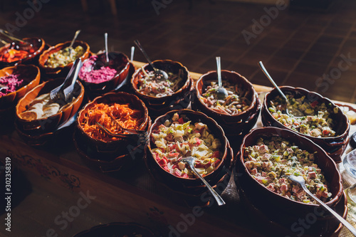Vászonkép Salad bar with various fresh vegetables and other foods.