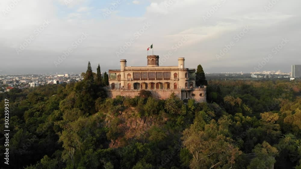 Drone slowly ascending in front of Chapultepec Castle to reveal Mexico City skyline at sunrise Drone slowly ascending in front of Chapultepec Castle to reveal Mexico City skyline at sunrise