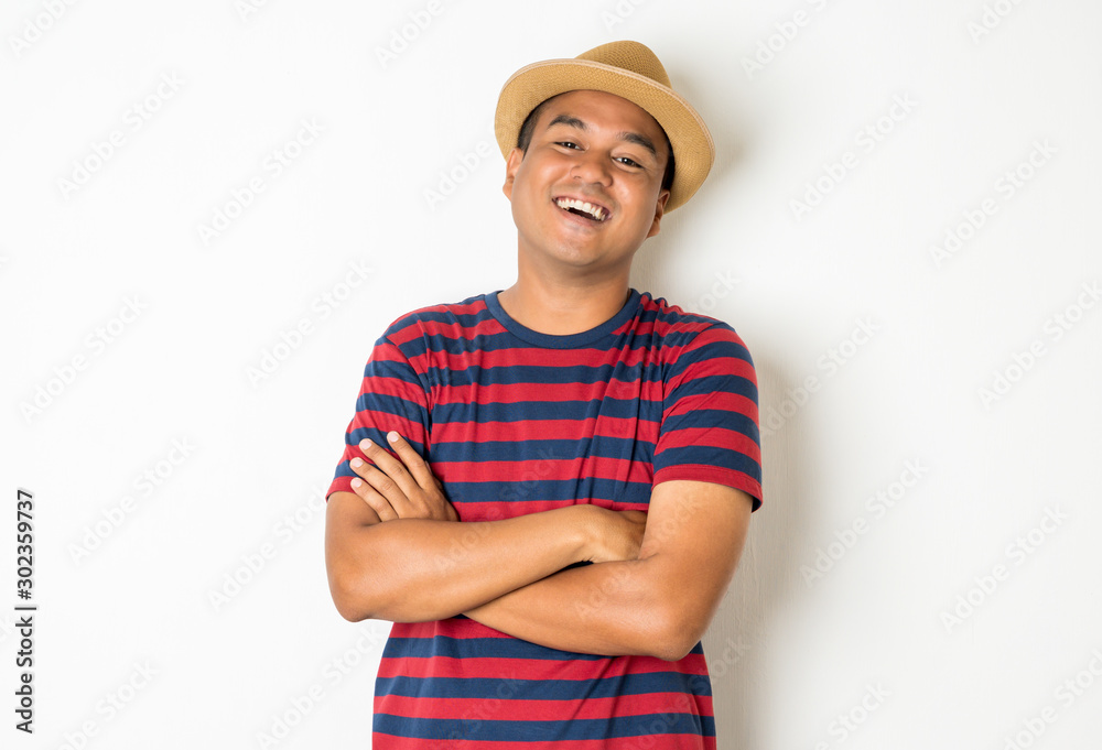 Portrait of an Asian man aged 27-35 who is currently enjoying Exhilarating And stood to cross his arms to express joy and happiness