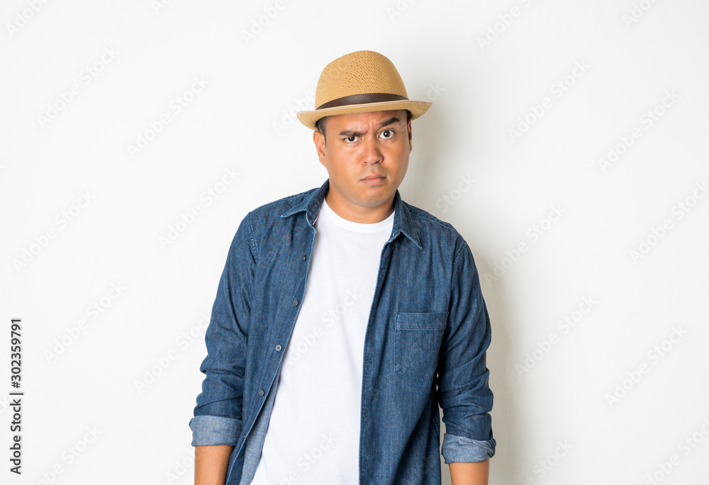 Asian men around the age of 27-35 are thinking and making faces, confused, not understanding, wondering with something.With a white background He wears a white shirt and jean shirt. Asian men around the age of 27-35 are thinking and making faces, confused, not understanding, wondering with something.With a white background He wears a white shirt and jean shirt.