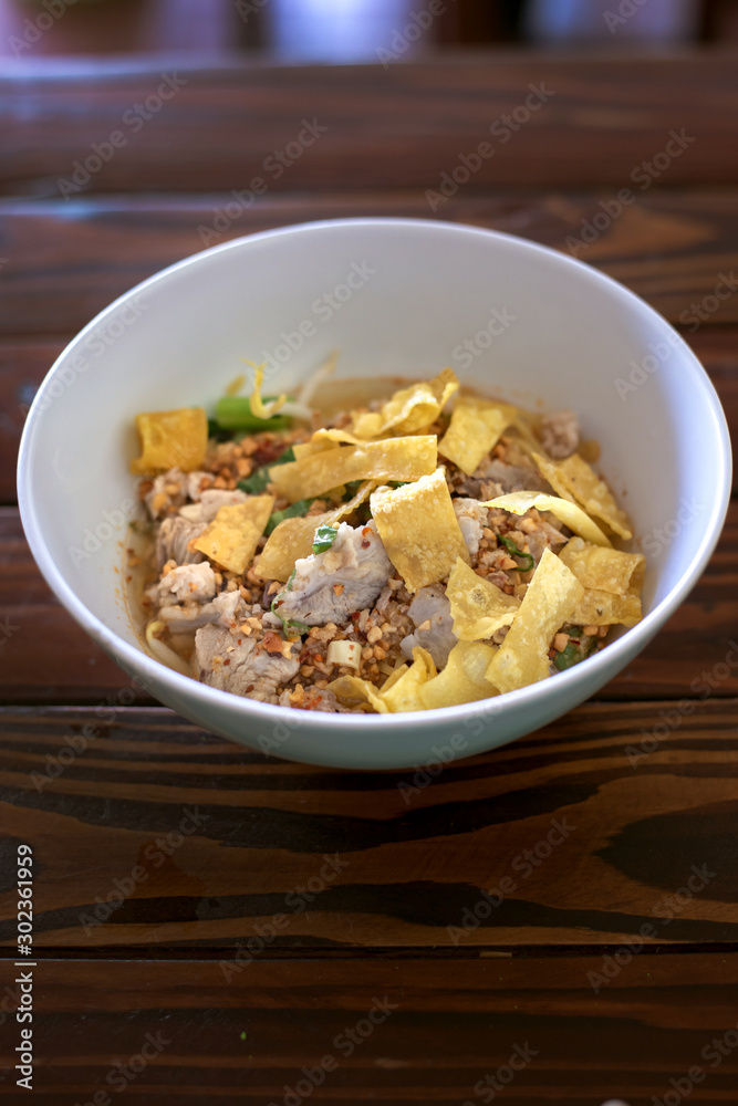 Spicy Pork spare ribs noodles with Crispy Sweet topped with grind peanut Spicy Pork spare ribs noodles with Crispy Sweet topped with grind peanut