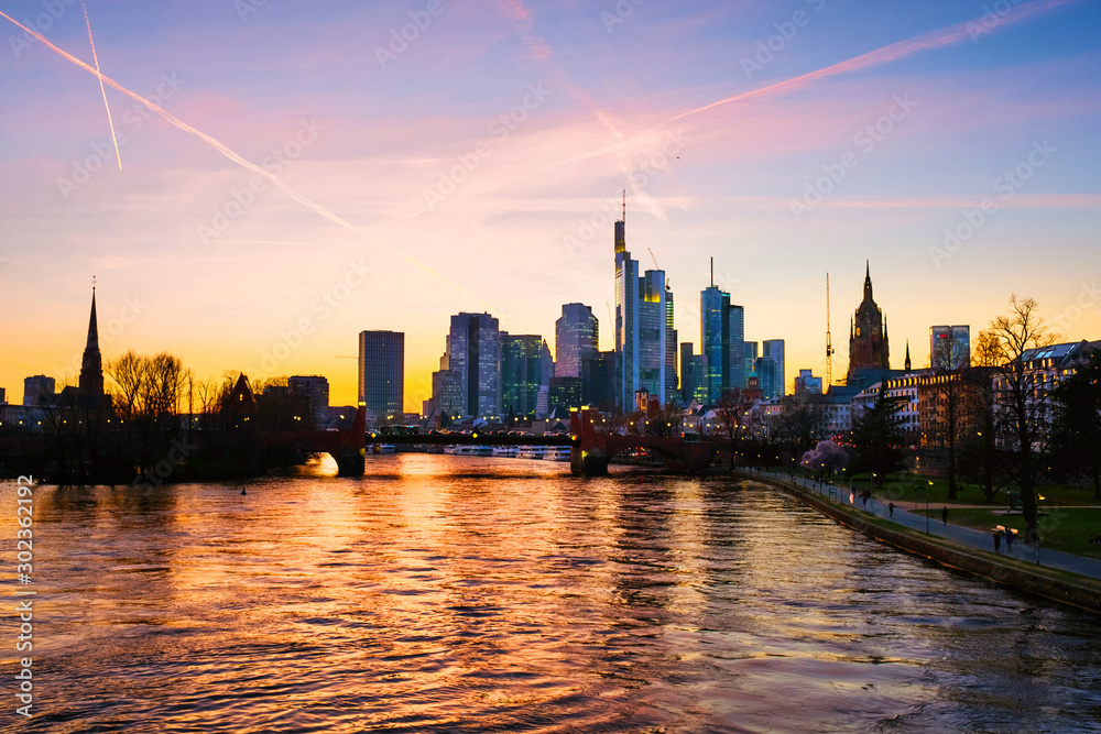 Skyline of Frankfurt, Germany in the sunset with famous illuminated skyscrapers