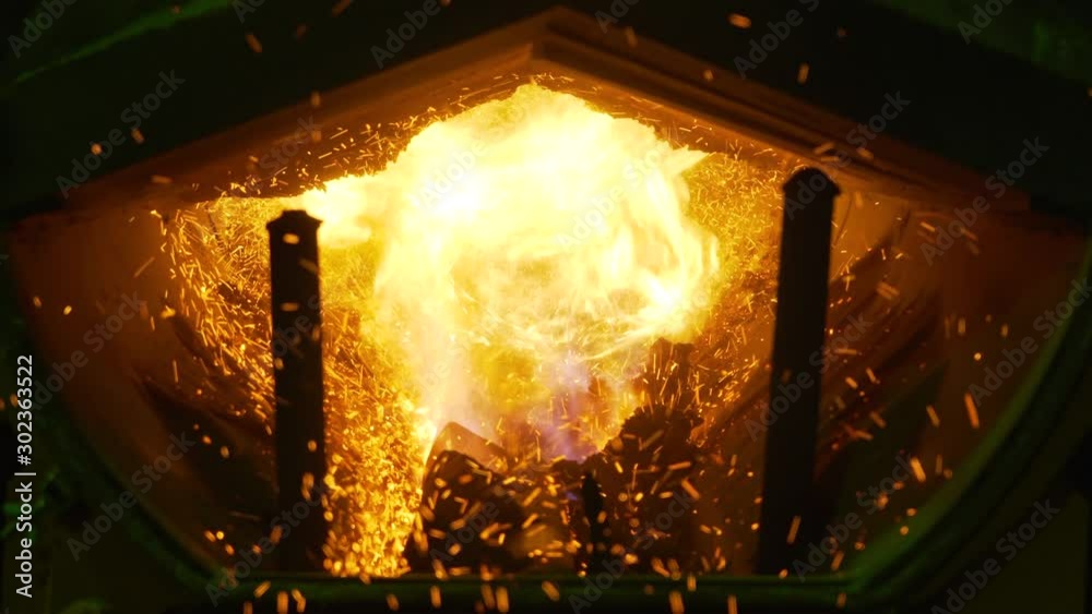 Powerful flame in boiler room, intense heat, sparks flying, high