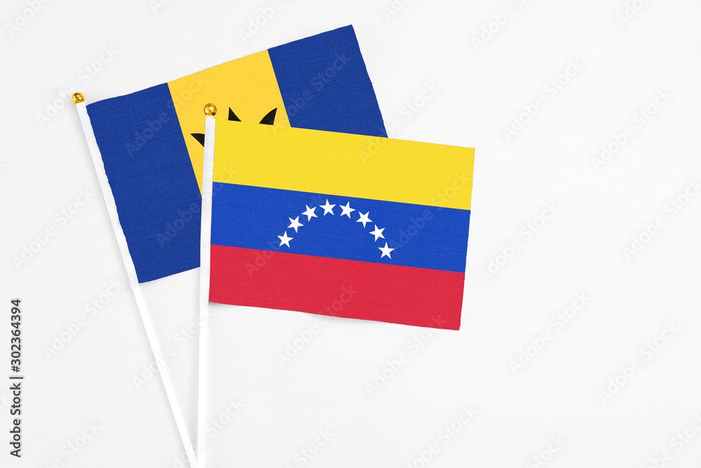 Venezuela and Barbados stick flags on white background. High quality fabric, miniature national flag. Peaceful global concept.White floor for copy space. Venezuela and Barbados stick flags on white background. High quality fabric, miniature national flag. Peaceful global concept.White floor for copy space.