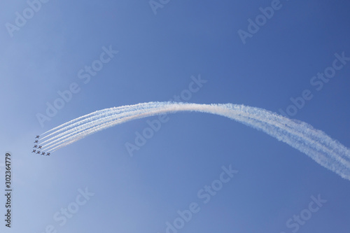 Small airplanes on air show with smoky trail