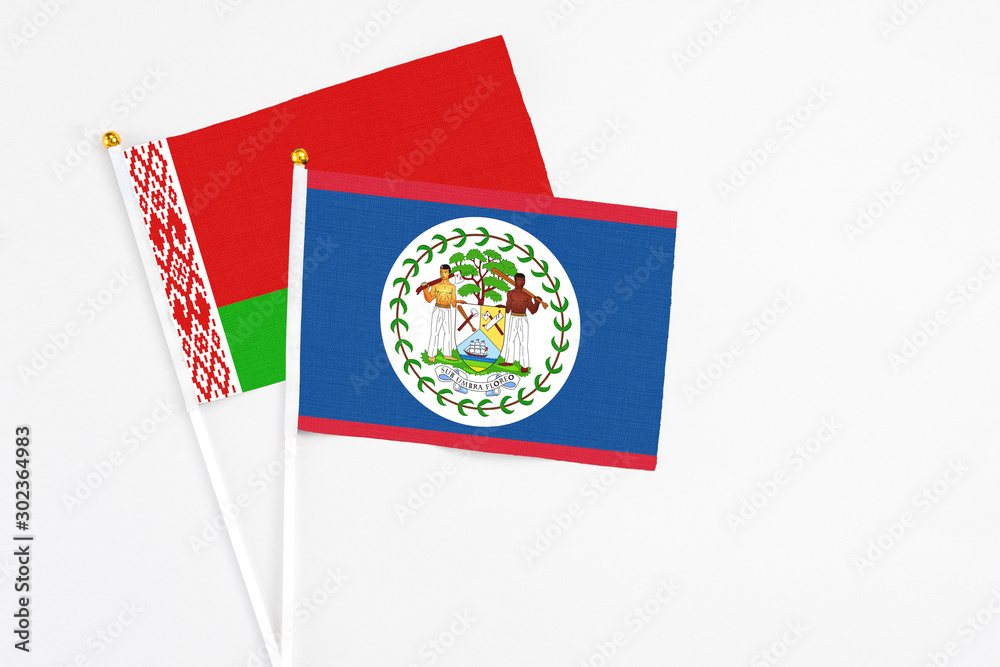Belize and Belarus stick flags on white background. High quality fabric, miniature national flag. Peaceful global concept.White floor for copy space. Belize and Belarus stick flags on white background. High quality fabric, miniature national flag. Peaceful global concept.White floor for copy space.