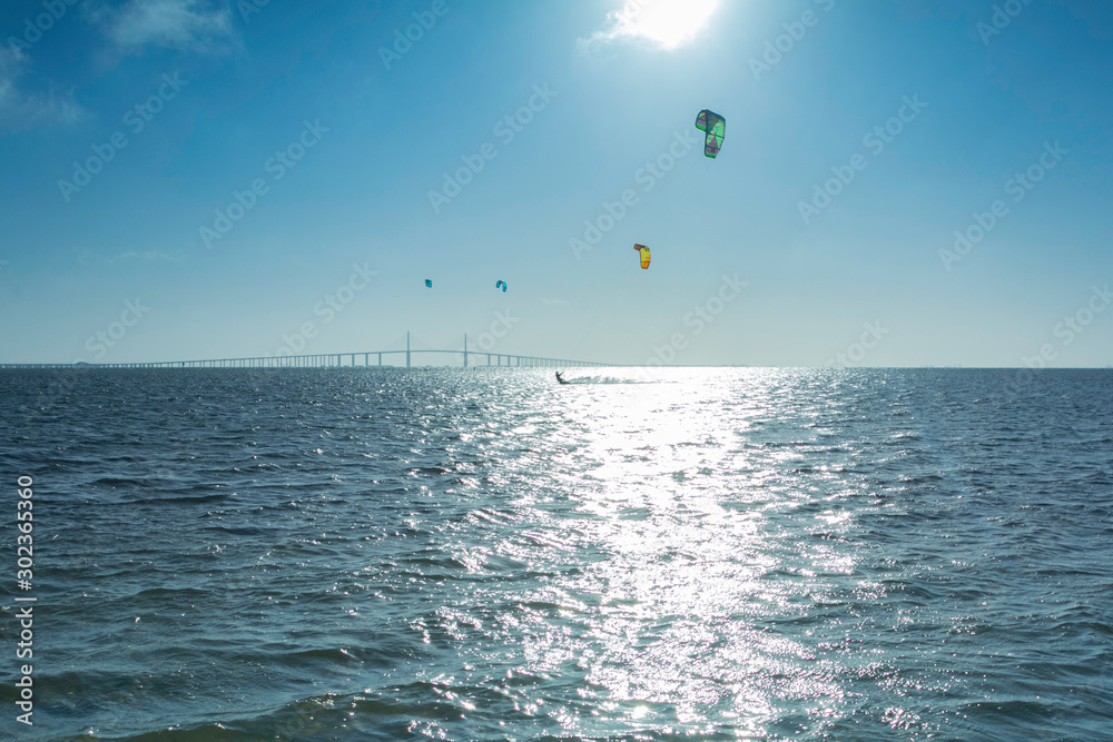 Kite surfing in the sea with the bridge over sea in background. Kite surfing in the sea with the bridge over sea in background.
