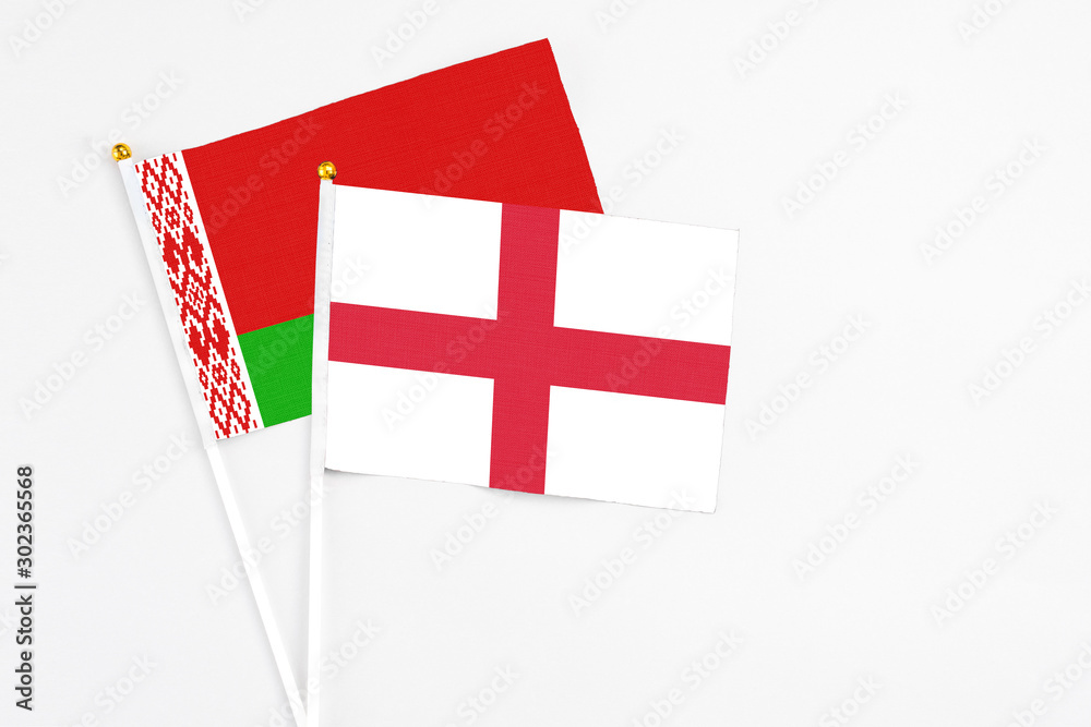 England and Belarus stick flags on white background. High quality fabric, miniature national flag. Peaceful global concept.White floor for copy space.