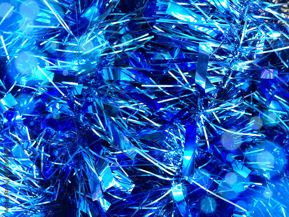 Obraz Christmas background, blue texture with abstract christmas decorations. Concept background for New Year and Christmas holidays 2020 with sparkles, needles and tinsel. Bright luminous pattern copyspace