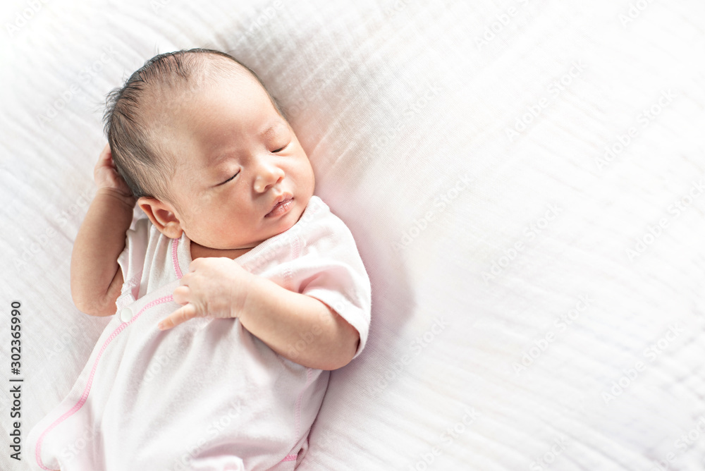 Happy Adorable baby girl sleeping in crib. Small kid having day nap in parents bed Happy Adorable baby girl sleeping in crib. Small kid having day nap in parents bed