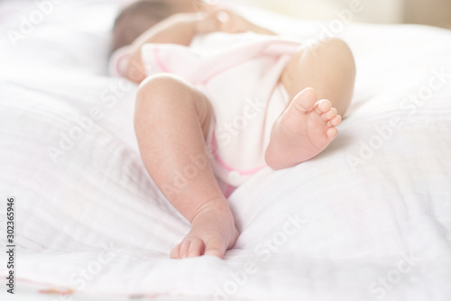 Newborn baby feet on a white blanket - tiny baby feet closeup