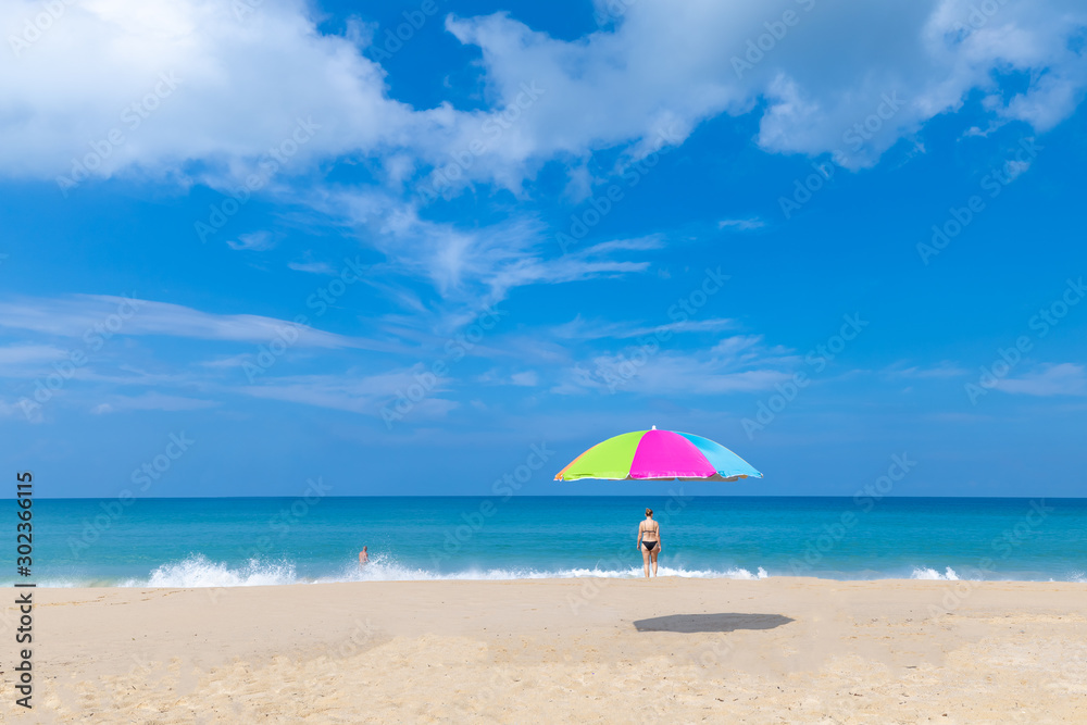 summer holiday concept and idea floating umbrella and travel tourists on the beach