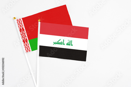 Iraq and Belarus stick flags on white background. High quality fabric, miniature national flag. Peaceful global concept.White floor for copy space. photo