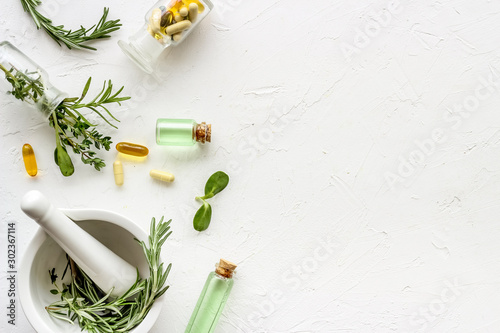 Apothecary of natural wellness and self-care. Herbs and medicine on white background top view frame copy space photo
