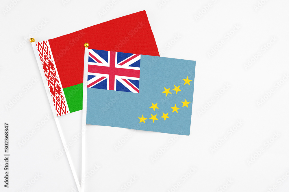 Tuvalu and Belarus stick flags on white background. High quality fabric, miniature national flag. Peaceful global concept.White floor for copy space. Tuvalu and Belarus stick flags on white background. High quality fabric, miniature national flag. Peaceful global concept.White floor for copy space.