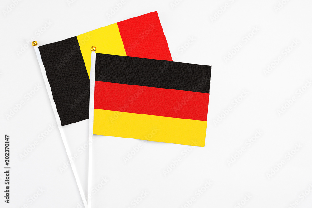 Germany and Belgium stick flags on white background. High quality fabric, miniature national flag. Peaceful global concept.White floor for copy space. Germany and Belgium stick flags on white background. High quality fabric, miniature national flag. Peaceful global concept.White floor for copy space.