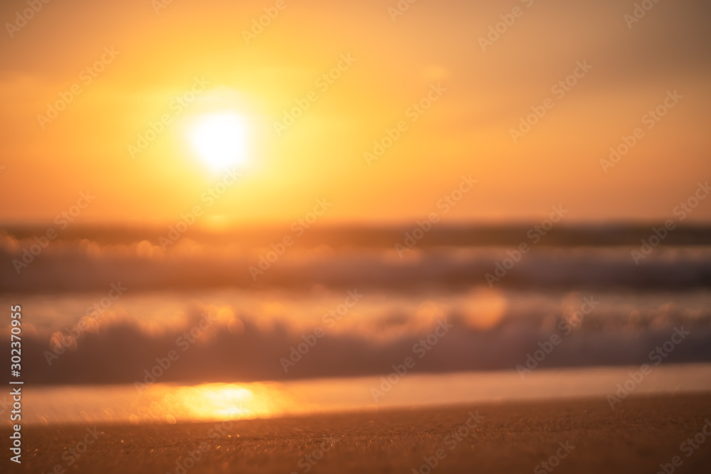 Fototapeta premium Copy space of soft sand sea and blur tropical beach with sunset sky and cloud abstract background.