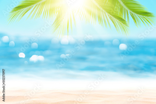 Blur beautiful nature green palm leaf on tropical beach with bokeh sun light ...