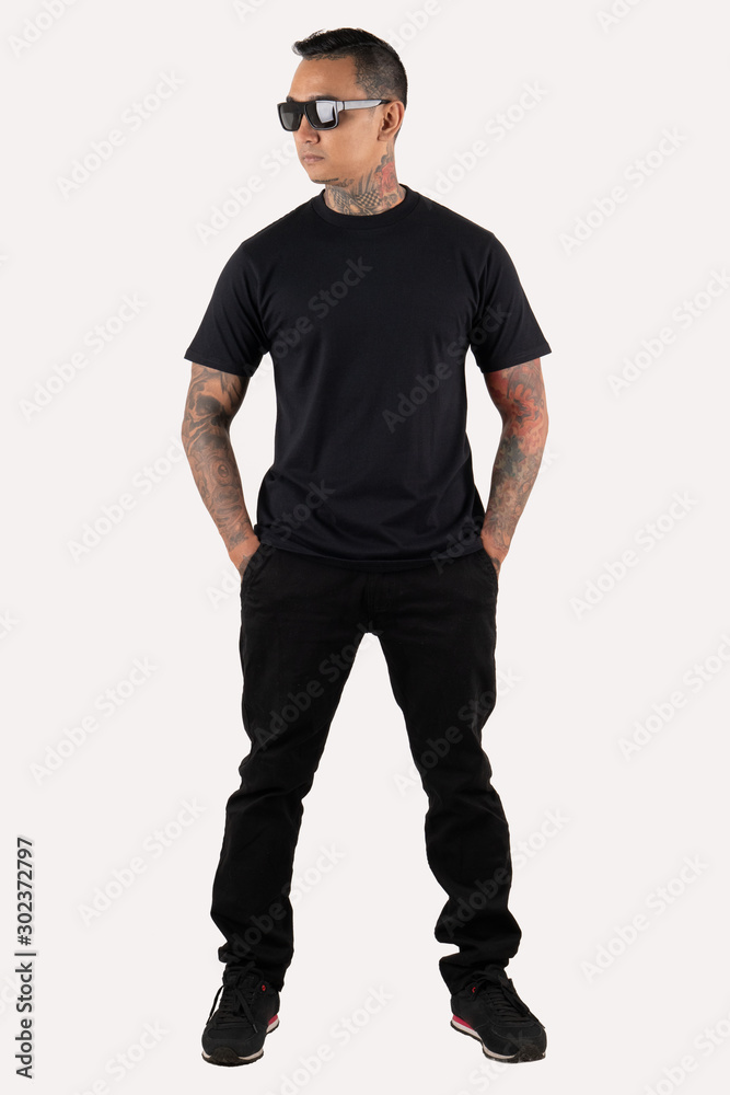 Tattooed man wearing black t-shirt and sunglasses isolated on white background. Tattooed man wearing black t-shirt and sunglasses isolated on white background.