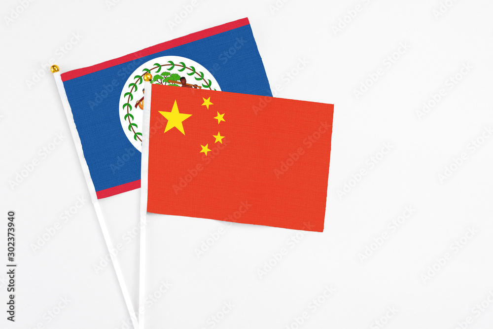 China and Belize stick flags on white background. High quality fabric, miniature national flag. Peaceful global concept.White floor for copy space. China and Belize stick flags on white background. High quality fabric, miniature national flag. Peaceful global concept.White floor for copy space.