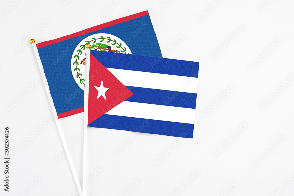 Cuba and Belize stick flags on white background. High quality fabric, miniature national flag. Peaceful global concept.White floor for copy space. Cuba and Belize stick flags on white background. High quality fabric, miniature national flag. Peaceful global concept.White floor for copy space.