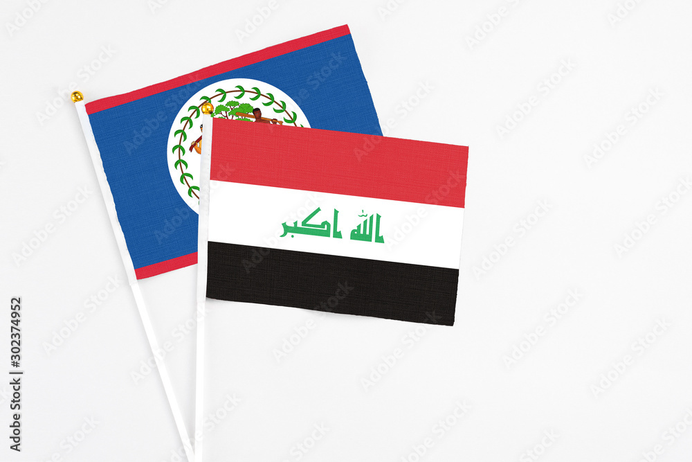 Iraq and Belize stick flags on white background. High quality fabric, miniature national flag. Peaceful global concept.White floor for copy space.