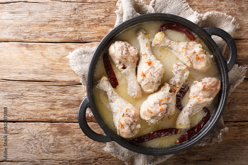 Traditional bengali chicken rezala in white curry sauce with chili