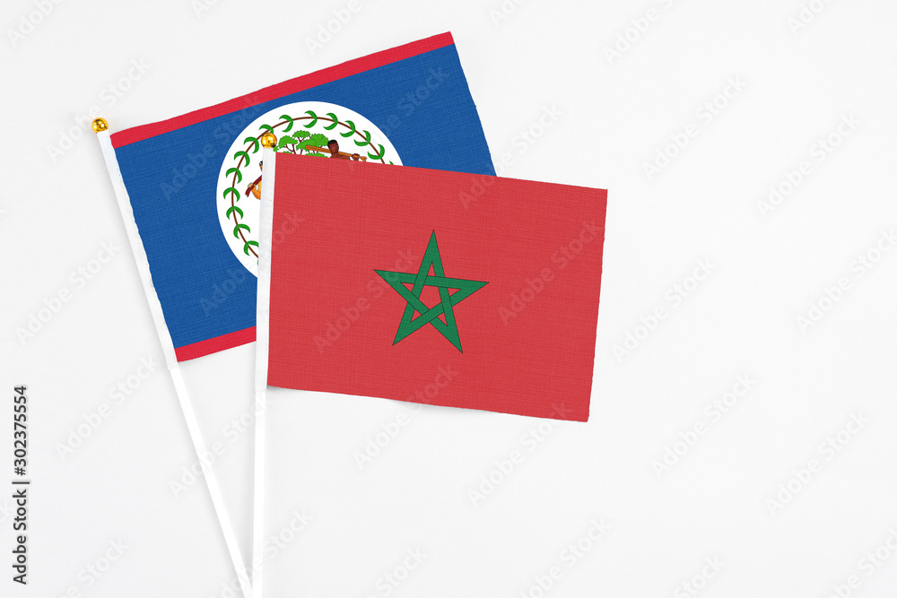 Morocco and Belize stick flags on white background. High quality fabric, miniature national flag. Peaceful global concept.White floor for copy space. Morocco and Belize stick flags on white background. High quality fabric, miniature national flag. Peaceful global concept.White floor for copy space.