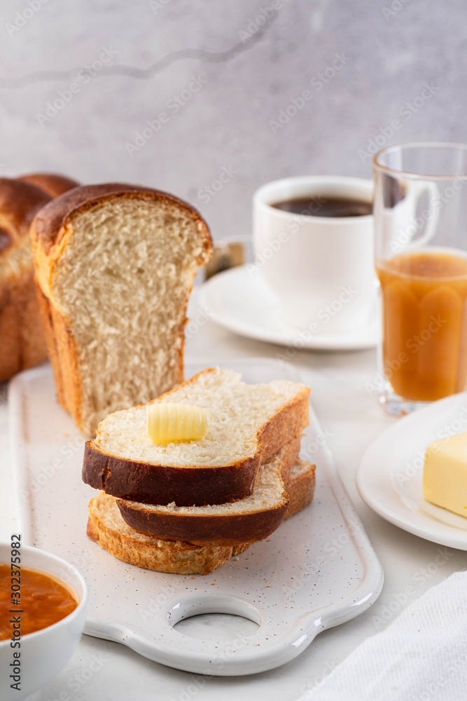 Freshly brioche bread and butter, juice and jam. Continental breakfast. Freshly brioche bread and butter, juice and jam. Continental breakfast.