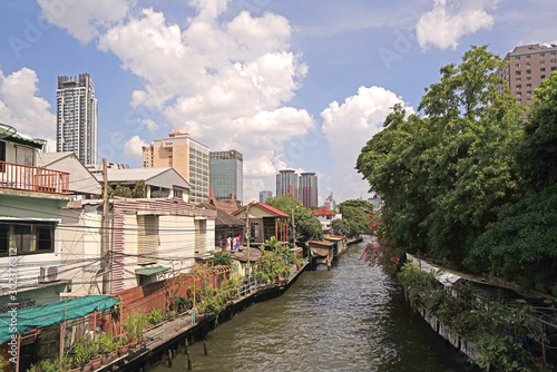 Thailand residential apartment, river, footpath and tree at daytime.
