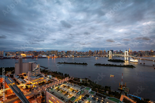 TOKYO, JAPAN - OCTOBER 6, 2019: The majestic Rainbow Bridge crossing northern Tokyo Bay between Shibaura Pier and the Odaiba waterfront. photo