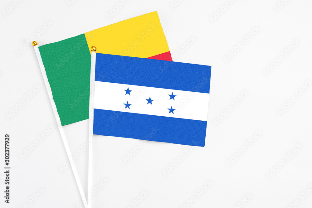 Honduras and Benin stick flags on white background. High quality fabric, miniature national flag. Peaceful global concept.White floor for copy space. Honduras and Benin stick flags on white background. High quality fabric, miniature national flag. Peaceful global concept.White floor for copy space.