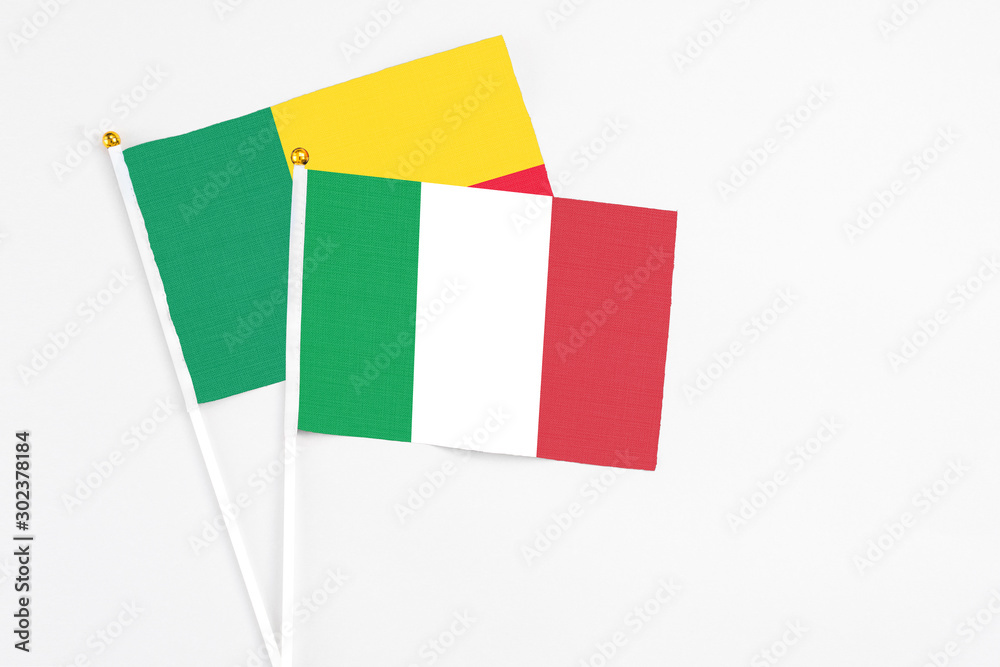 Italy and Benin stick flags on white background. High quality fabric, miniature national flag. Peaceful global concept.White floor for copy space. Italy and Benin stick flags on white background. High quality fabric, miniature national flag. Peaceful global concept.White floor for copy space.