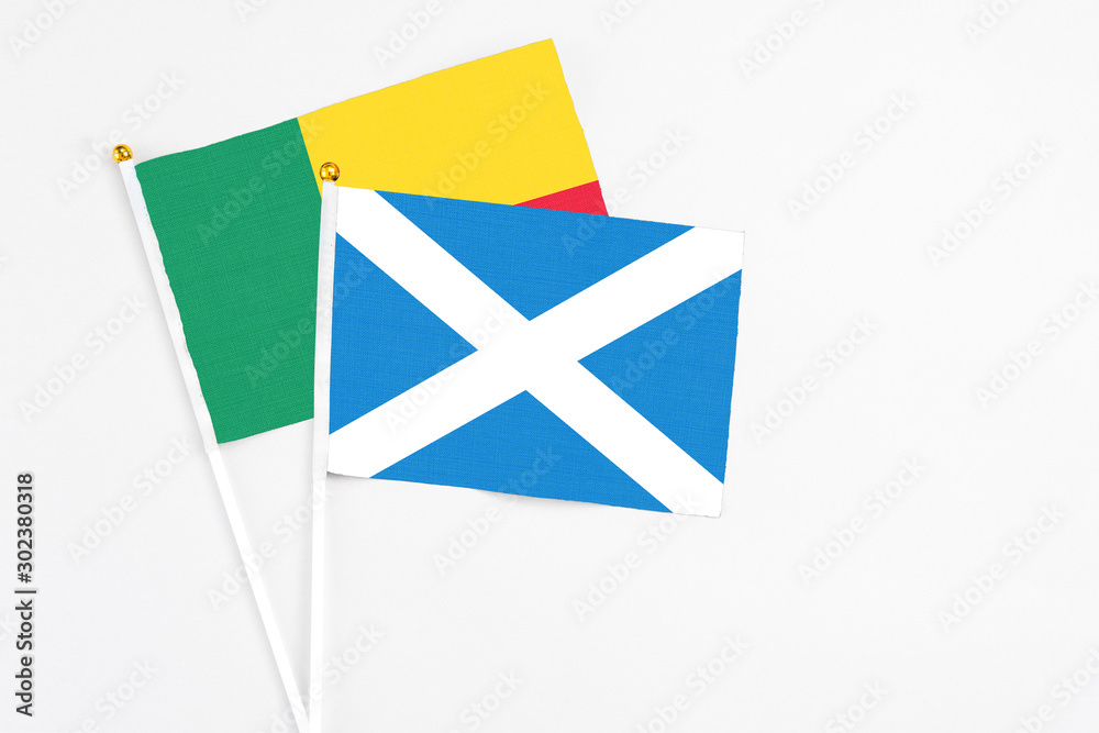 Scotland and Benin stick flags on white background. High quality fabric, miniature national flag. Peaceful global concept.White floor for copy space. Scotland and Benin stick flags on white background. High quality fabric, miniature national flag. Peaceful global concept.White floor for copy space.