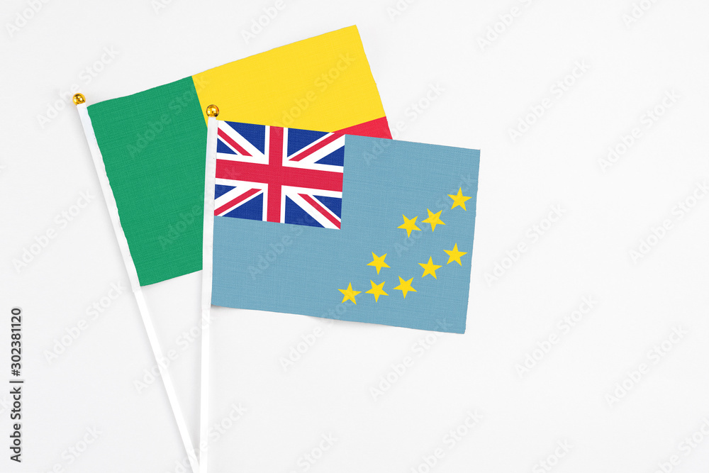 Tuvalu and Benin stick flags on white background. High quality fabric, miniature national flag. Peaceful global concept.White floor for copy space. Tuvalu and Benin stick flags on white background. High quality fabric, miniature national flag. Peaceful global concept.White floor for copy space.