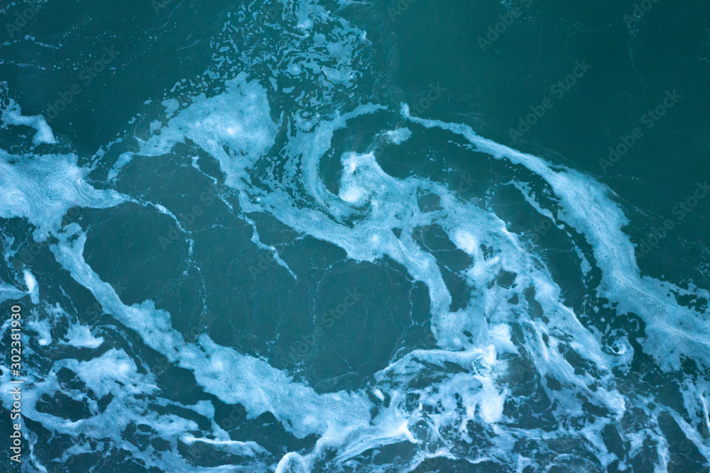 Cyan, turquoise water texture with white foam on waves Cyan, turquoise water texture with white foam on waves