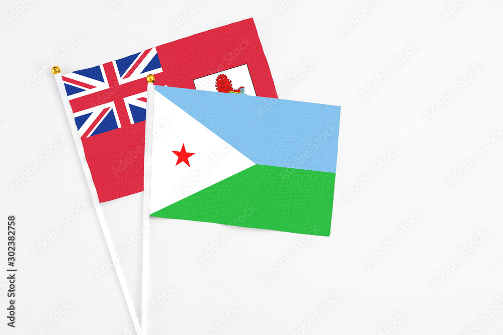 Djibouti and Bermuda stick flags on white background. High quality fabric, miniature national flag. Peaceful global concept.White floor for copy space. Djibouti and Bermuda stick flags on white background. High quality fabric, miniature national flag. Peaceful global concept.White floor for copy space.
