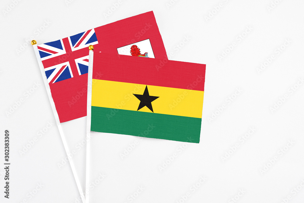 Ghana and Bermuda stick flags on white background. High quality fabric, miniature national flag. Peaceful global concept.White floor for copy space.