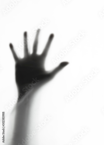 Blurred shadow of hand behind  curtain background,blurry hand of robber,murderer or stranger,concept of scary crime scene of horror or thriller movies,Halloween theme