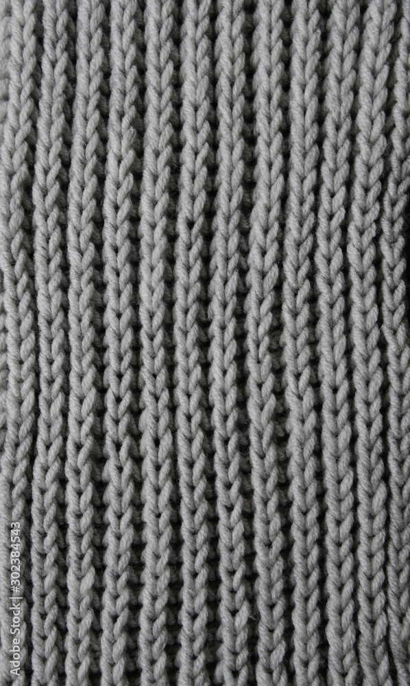 Abstract knitting fabric background. Gray texture background from merino knitted blanket, scandinavian minimalism backdrop with copy space, top view. Vertical concept Abstract knitting fabric background. Gray texture background from merino knitted blanket, scandinavian minimalism backdrop with copy space, top view. Vertical concept