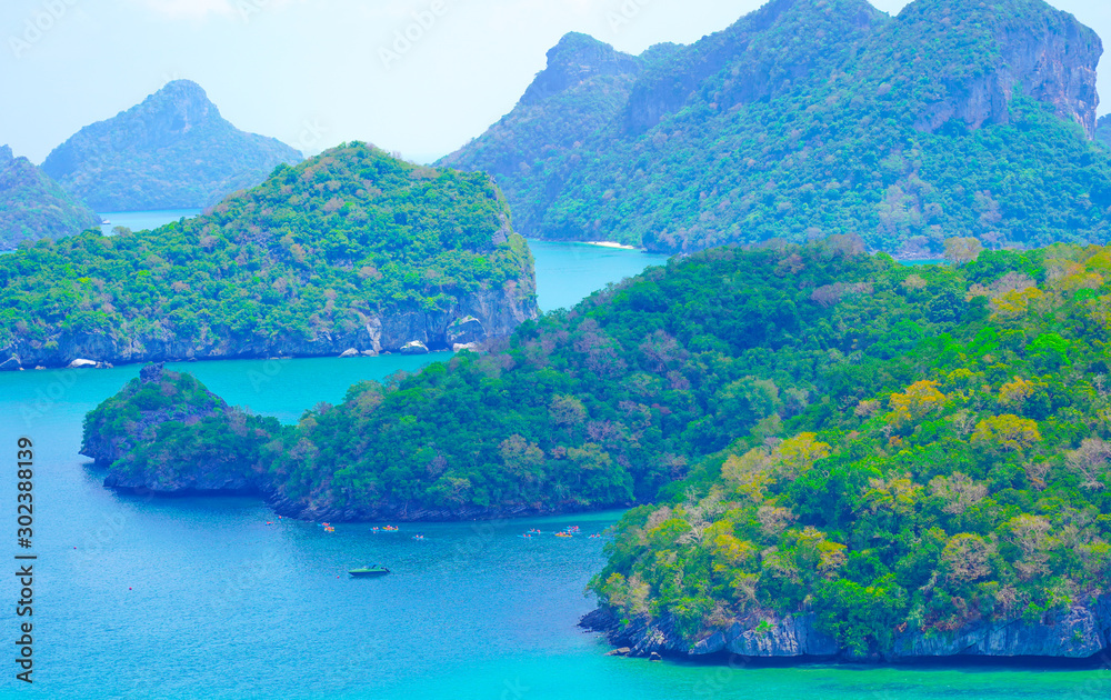 Islands green lush tropical island in a blue and turquoise sea background