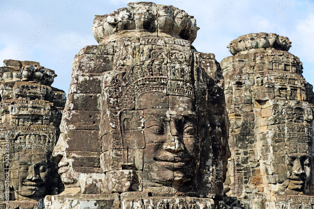 Fototapeta premium Ancient stone faces of Bayon temple in complex Angkor Wat in Siem Reap, Cambodia 