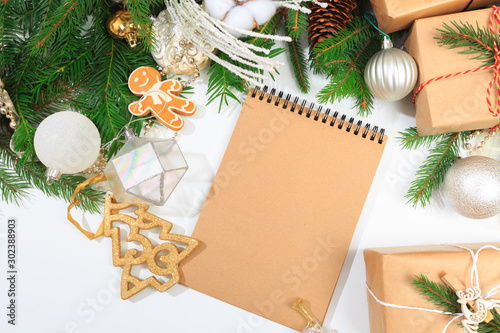 Top view of blank notebook on white background with xmas decorations. Mockup Christmas background with notebook for wish list or to do list. Flat lay with copy space. - Image