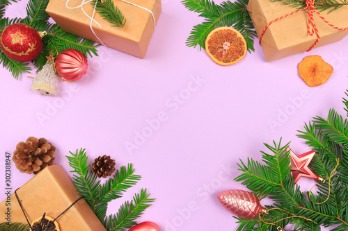 Christmas border. Christmas gifts, fir branches on color background. Flat lay, top view, copy space - Image