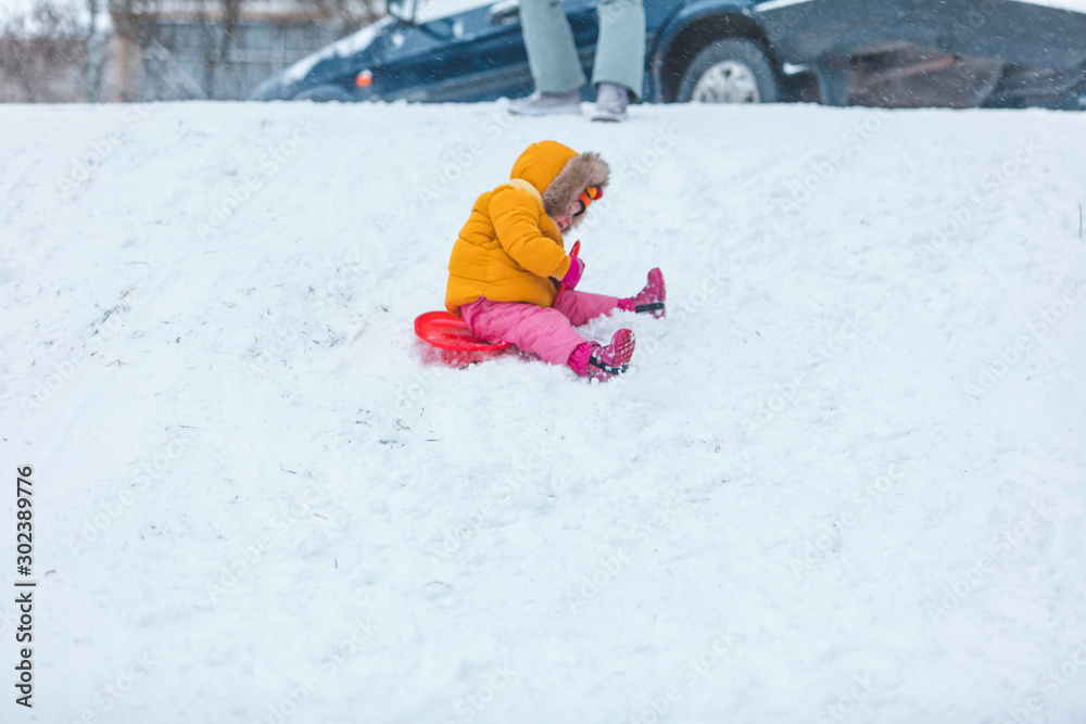 little girl playing outdoors in snow